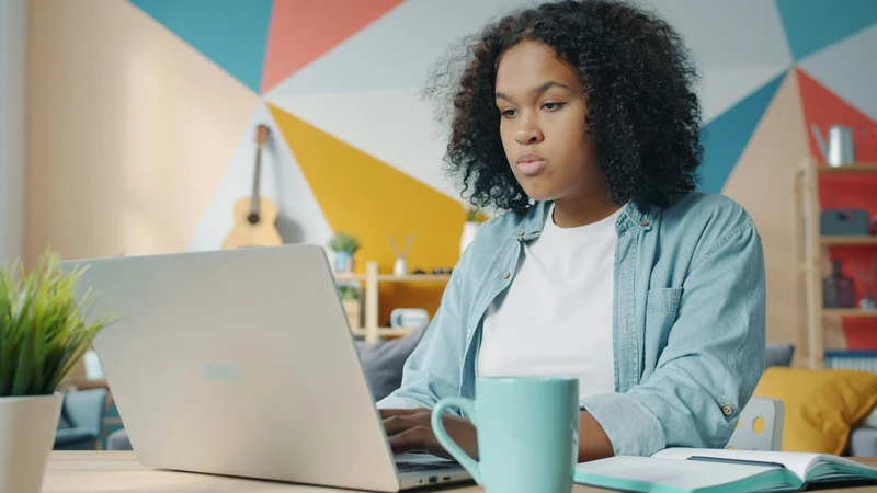 Person working remotely on a laptop from home