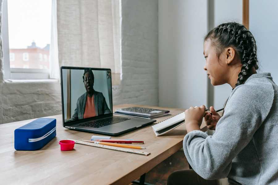 Online Tutoring Jobs for Beginners teacher desk setup with laptop and study material